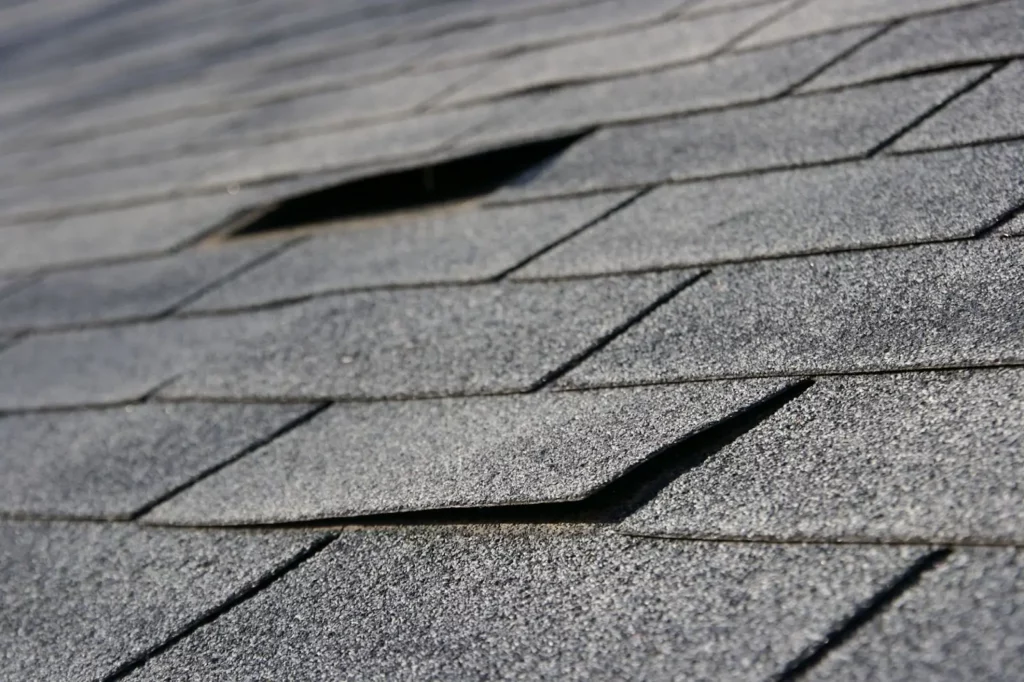 Lifting asphalt shingles causing roof damage